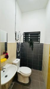 a bathroom with a toilet and a sink at 122 Segari in Lumut +40 photos