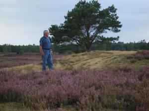 a man standing in a field of purple flowers at Holiday apartment in Nahrendorf with barbecue in Nahrendorf