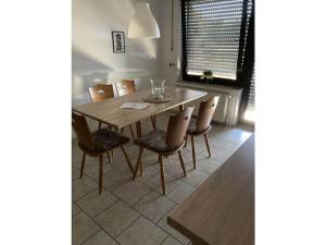 a dining room with a wooden table and chairs at Holiday apartment in Nahrendorf with barbecue in Nahrendorf
