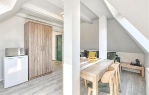 a kitchen and dining room with a table and a refrigerator at 3 Bedroom Awesome Apartment In Altenkirchen in Altenkirchen