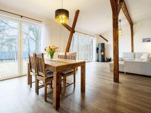 a living room with a wooden table and chairs at West barn at Mühlendamm in Steinbergkirche
