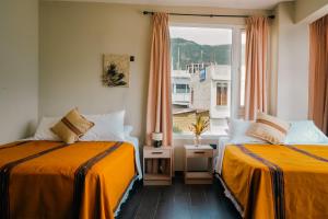 Giường trong phòng chung tại Casa Lolita's