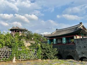 a building with a fence in front of it at Zen House Suwon Hwaseong in Suwon
