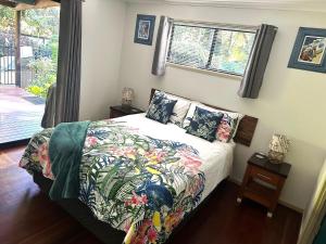 ein Schlafzimmer mit einem Bett mit einer farbenfrohen Tagesdecke in der Unterkunft Beachcomber - Rainbow Shores in Rainbow Beach + 14 Fotos