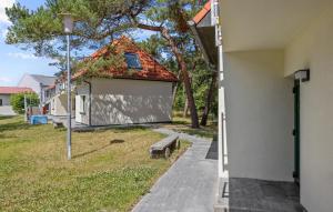 a white building with a bench next to a sidewalk at Beautiful Apartment In Altenkirchen With Wifi in Altenkirchen