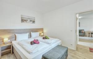 a bedroom with a large white bed with two pillows at Nice Apartment In Altenkirchen in Altenkirchen
