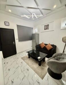 a living room with a couch and a coffee table at Bisola Residences in Cotonou +6 photos