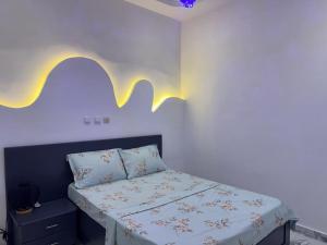 a bedroom with a bed with a white bedspread at Bisola Residences in Cotonou