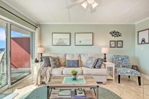 a living room with a couch and a table at Couple's Corner - 2 Blocks to the Boardwalk - Panoramic Views of Assateague Island, Bay and Ocean - Assateague House 411 in Ocean City