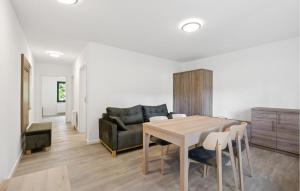 a living room with a table and a couch at Amazing Apartment In Altenkirchen With Wifi in Altenkirchen