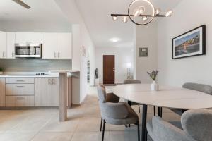 a kitchen and dining room with a table and chairs at Villa Serena Luxury Home with Private Pool- close to BQN in Maleza