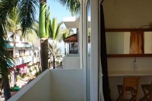 a balcony with a view of a palm tree at Nicho Suite @ Sayulita Surfside Suites in Sayulita
