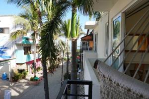 a balcony with palm trees and a building at Nicho Suite @ Sayulita Surfside Suites in Sayulita