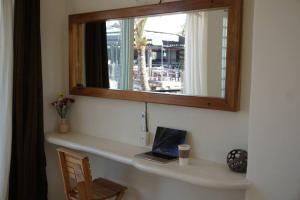 a laptop sitting on a counter under a mirror at Nicho Suite @ Sayulita Surfside Suites in Sayulita +4 photos