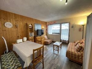 a small living room with a table and a couch at Studio 4 personnes avec balcon, proche pistes, animaux acceptés - FR-1-572-312 in Les Carroz d'Araches