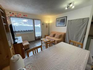 a small living room with a couch and a table at Studio 4 personnes avec balcon, proche pistes, animaux acceptés - FR-1-572-312 in Les Carroz d'Araches
