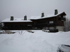 a house with a pile of snow in front of it at Studio 4 personnes avec balcon, proche pistes, animaux acceptés - FR-1-572-312 in Les Carroz d'Araches +2 photos