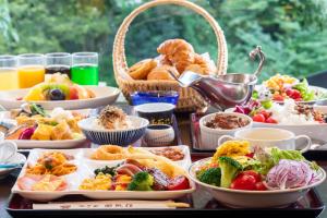 a table topped with plates of food and bowls of food at Hotel Nanpuso in Hakone