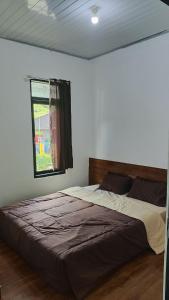 Ένα ή περισσότερα κρεβάτια σε δωμάτιο στο Mustika Dieng Homestay Fullhouse +2 φωτογραφίες