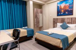 a hospital room with two beds and a desk at Hotel Konford Cañete in Imperial