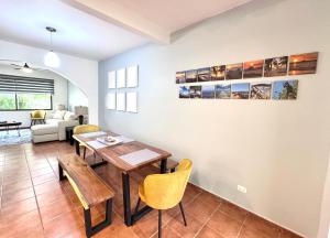 a living room with a wooden table and chairs at Gorgeous Three Bedroom Townhouse in Coco