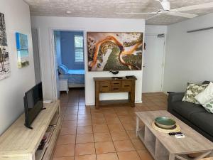 a living room with a couch and a table at Baden 26 - Rainbow Shores - Swimming pools - Tennis court - Walk to beach in Rainbow Beach
