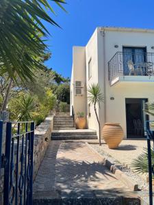 a house with stairs and plants in front of it at Nefeli Villas in Hersonissos