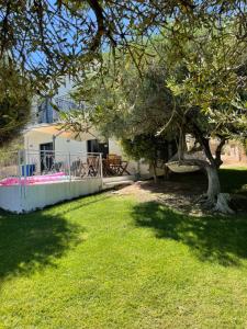 a house with a tree in the yard at Nefeli Villas in Hersonissos