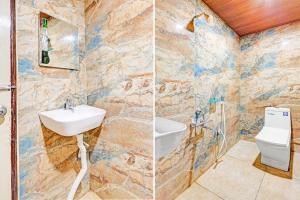 a bathroom with a sink and a toilet at Collection O Vijayawada South India Shopping Mall in Vijayawāda