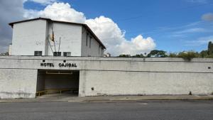 a building with a garage with a sign on it at Hotel Cajigal Caracas in Caracas