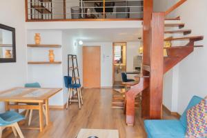 a living room and dining room with a spiral staircase at 100 Wonderful House in Bogotá