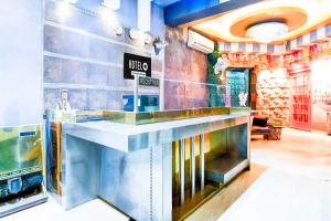 a restaurant with a counter in a room at Hotel O Circus Avenue Road in Kolkata