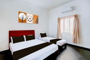 Ένα ή περισσότερα κρεβάτια σε δωμάτιο στο Hotel O Mysuru Sand Museum