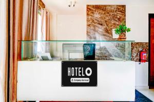 a hotel counter with a sign on it at Townhouse Mysuru Sand Museum in Mysore