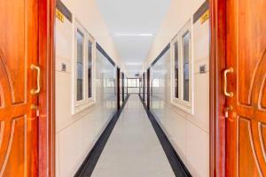an empty corridor of a train with doors open at Hotel O Vellore Near CMC Hospital in Vellore
