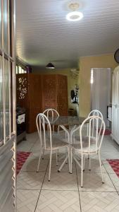 a dining room with a table and two chairs at Studio Funcional in Guaraqueçaba +18 photos