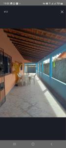 a patio with tables and benches on a building at Casa de Praia em Salinopolis-Pará in Salinópolis