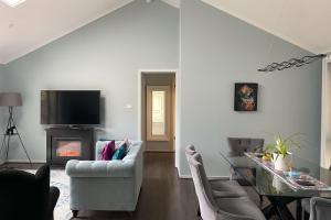 a living room with a couch and a fireplace at Blue Jay Daylesford in Daylesford
