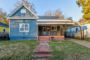 a blue house with a fence in front of it at Midtown Magic Spacious Bungalow Steps From C-y in Memphis