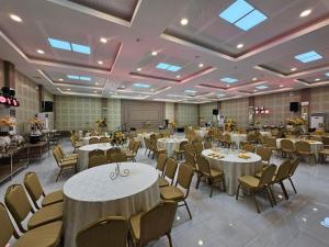 a banquet hall with white tables and chairs at District 21 Hotel in Iloilo City