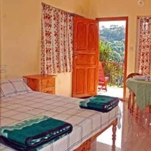 a bedroom with a bed with two suitcases on it at Whitehouse Homestay in Thekkady
