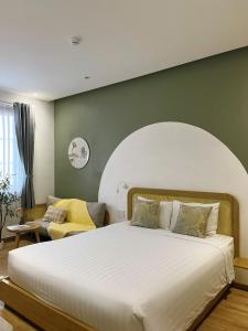 a bedroom with a large bed and a couch at Triland Hotel in Phú Quốc
