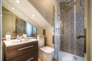 a bathroom with a shower and a toilet and a sink at Hotel Boutique Las Brisas in Santander