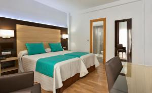 Postel nebo postele na pokoji v ubytování Hotel Baviera
