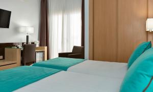 Postel nebo postele na pokoji v ubytování Hotel Baviera
