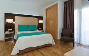 Postel nebo postele na pokoji v ubytování Hotel Baviera