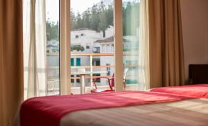 Postel nebo postele na pokoji v ubytování Hotel Baviera