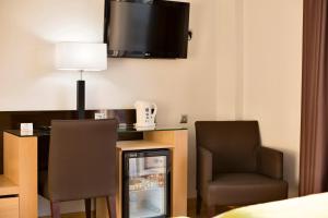 TV a/nebo společenská místnost v ubytování Hotel Baviera