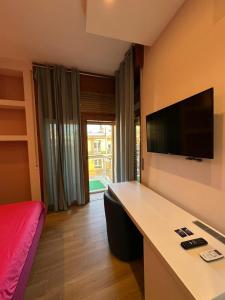 a room with a desk and a tv on a wall at VIP CIELO STELLATO on SEA VIEW SUITES in Salerno