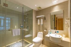a bathroom with a toilet and a sink and a shower at City Comfort Inn Dujiangyan Municipal Government in Chengdu +106 photos